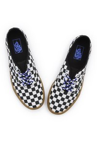 Zapatillas de cuadros en blanco y negro con cordones azules, suelas de goma y la marca Vans en la lengüeta. Diseño clásico de caña baja.