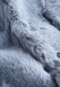 Gray faux fur fabric with soft, fluffy texture and varying lengths of hair, displaying a smooth surface and subtle sheen.