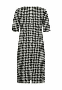 Houndstooth-kuvioinen mekko mustavalkoisena, lyhythihainen, polvipituinen, keskiselässä halkeamalla ja saumatonta rakennetta.