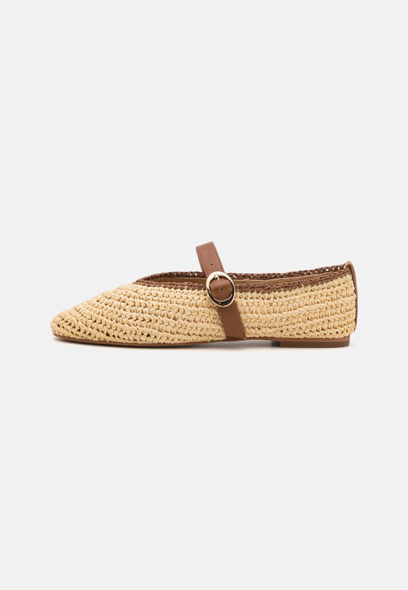 Woven straw flat shoe with a pointed toe, brown leather strap and metal buckle detailing. Textured surface, light tan color.
