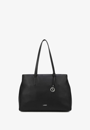 Borsa tote in pelle nera con due lunghe maniglie, un elemento circolare in metallo e un logo sottile in basso. Texture liscia e forma strutturata.
