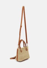 Tan leather-accented straw bag with a structured shape, woven texture, and top handles. Features adjustable strap and gold hardware.