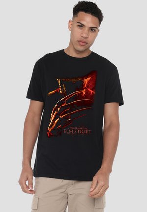Black cotton t-shirt featuring a red and gold graphic of a clawed hand and the text "A Nightmare on Elm Street" in white.