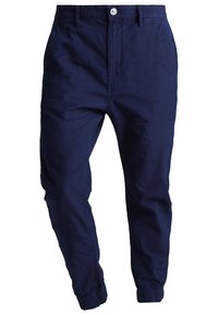 Marineblauwe, lichte, taps toelopende broek met een drawstring bij de manchetten, een platte voorkant, twee zijzakken en een knoopsluiting in de taille.