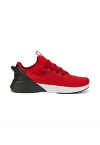Red athletic shoe with mesh upper and black accents. Features textured material, white midsole, and a pull tab on the heel for easier wear.