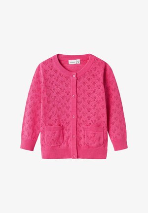 Różowy sweter z dzianiny z wzorem serc, okrągłym dekoltem, zapięciem na guziki, ściągaczami u rękawów oraz dwiema przednimi kieszeniami.
