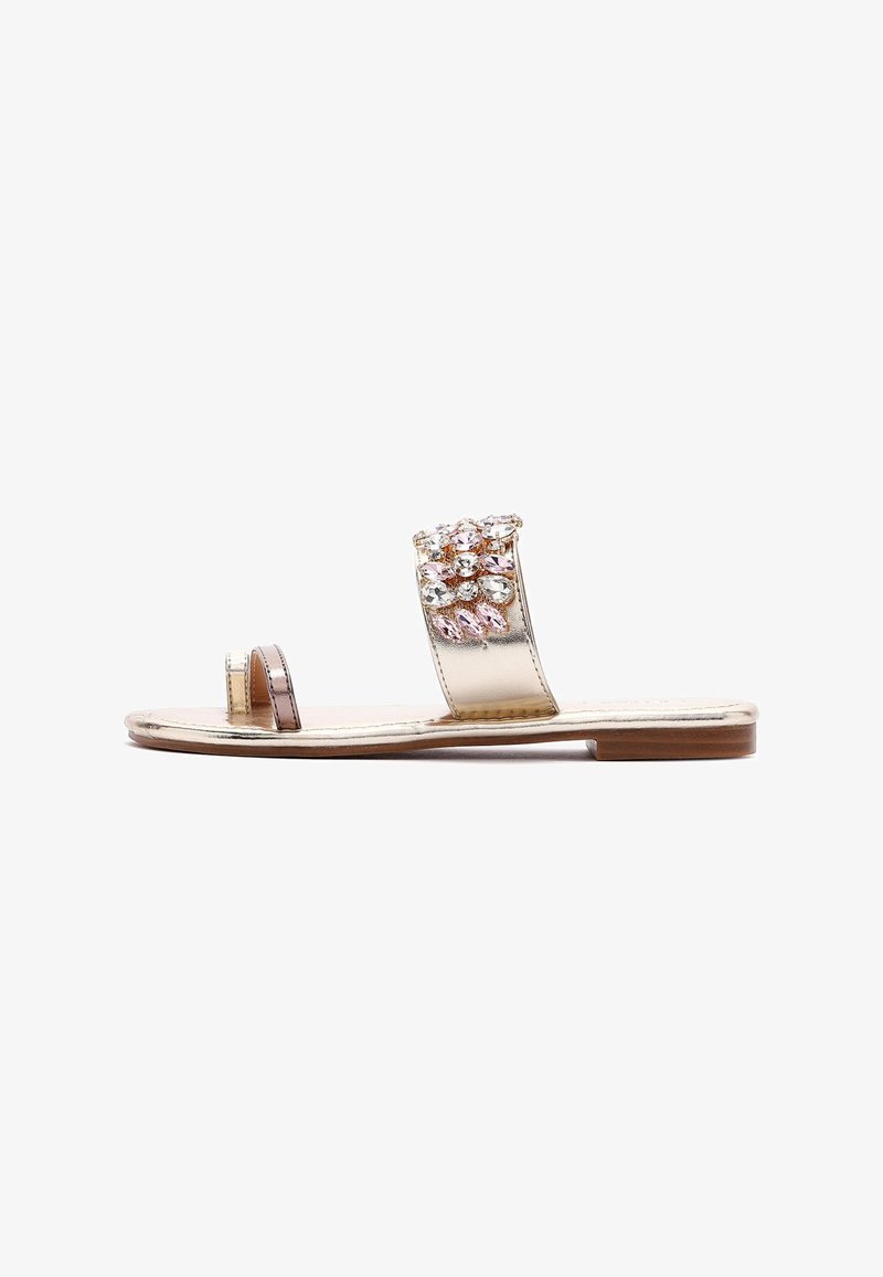 Gold metallic slide sandal featuring a wide strap adorned with clear and pink rhinestones, flat sole, and open toe design.