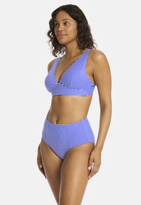 Niebieski i biały kostium bikini w paski, z topem o głębokim dekolcie i wysokim stanem. Gładki, elastyczny materiał i dopasowany krój.