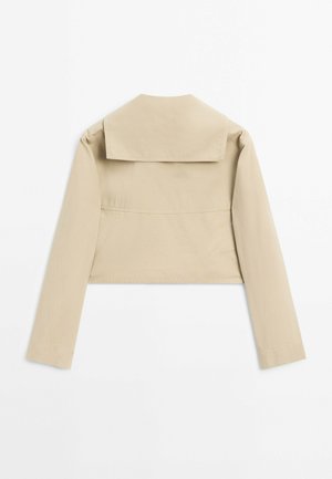 Cropped beige jacket featuring long sleeves, a wide collar, and a plain texture. The back has a seam detail for structure.