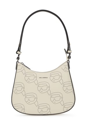 Beige Lederhandtasche mit geschwungener Form, schwarzen Akzenten und einem Punktmuster mit einem erkennbaren Gesichtdesign. Verfügt über einen verstellbaren Schultergurt.