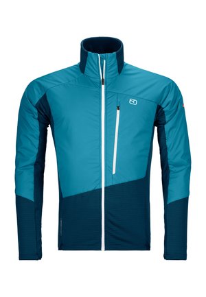 Leichte, isolierte Jacke mit hohem Kragen. Mit einem blauen und marinefarbenen Farbschema, einem mit Reißverschluss versehenen Brusttasche und kontrastierenden Texturen.