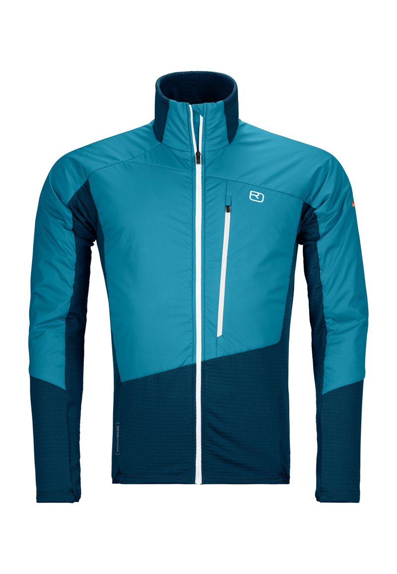 Lightweight, insulated jacket with a high collar. Features a blue and navy color scheme, zippered chest pocket, and contrasting textures.