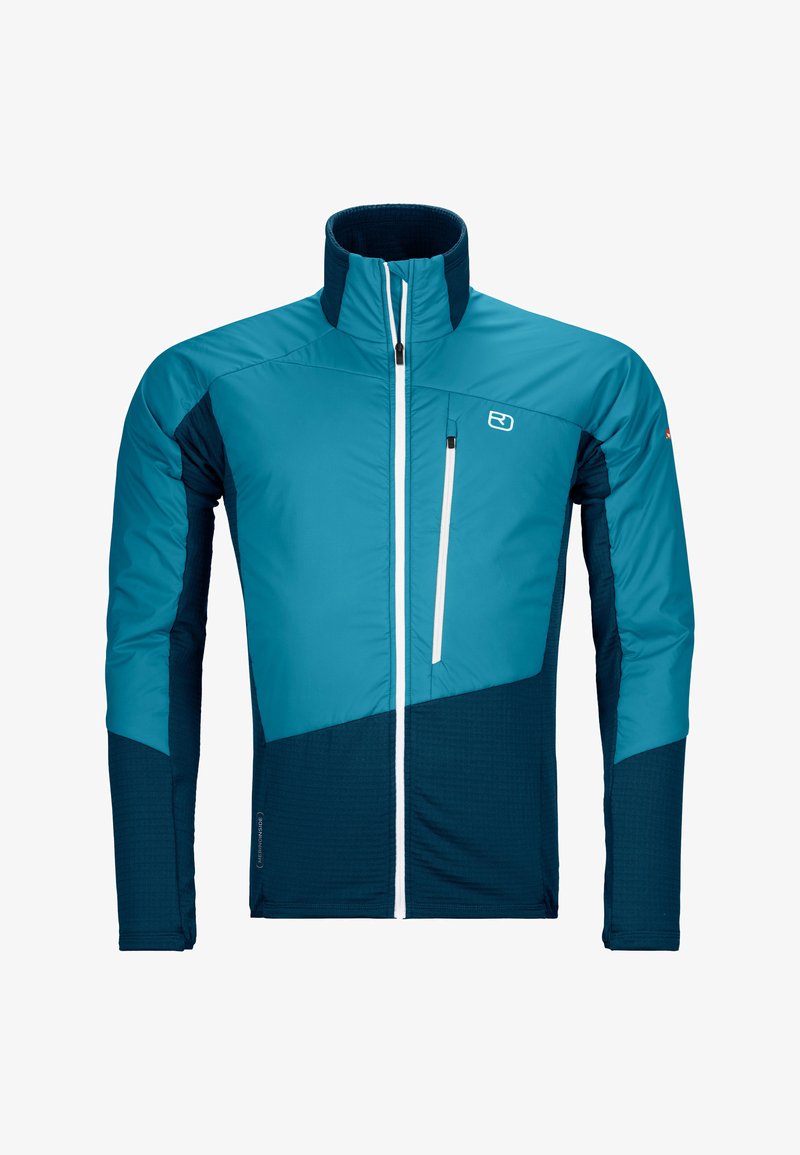 Lightweight, insulated jacket with a high collar. Features a blue and navy color scheme, zippered chest pocket, and contrasting textures.