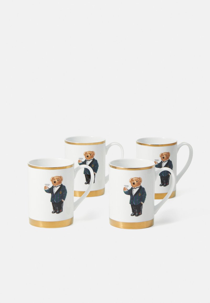 Komplet štirih belih keramičnih skodelic z zlatimi detajli in ilustracijo medveda v fraku, ki drži pijačo. Vsaka skodelica ima ročaj.