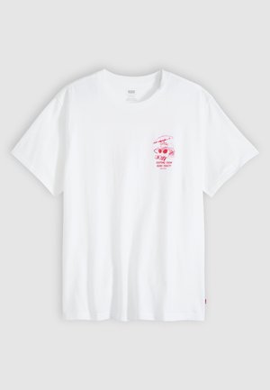 Weißes T-Shirt mit kurzen Ärmeln und kleinem rotem Motiv auf der linken Brust, das Picknickgegenstände und den Text "KEEPING THEM BUNS TOASTY" zeigt.