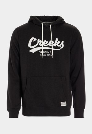Felpa nera realizzata in tessuto morbido con tasca frontale. Presenta un logo bianco "Creeks" e coulisse, maniche testurizzate e orlo a coste.