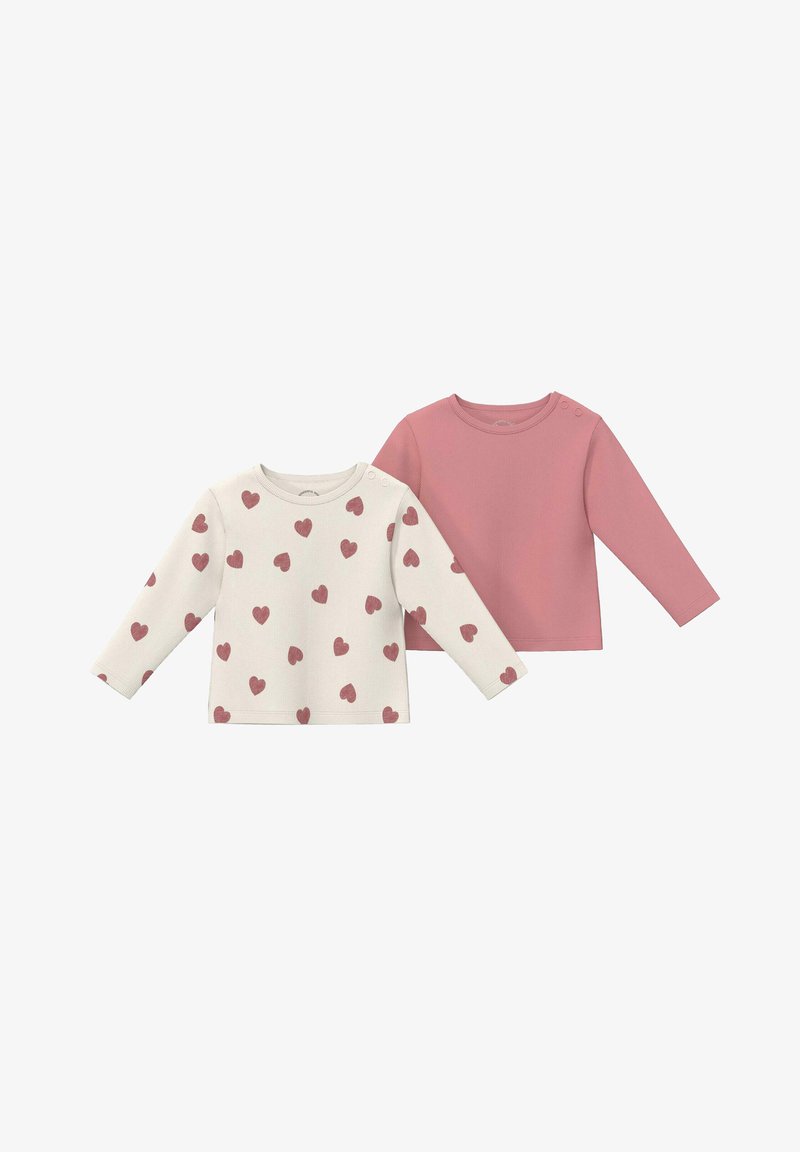 Deux chemises pour bébé à manches longues, une rose poussiéreuse unie, une crème avec un motif de cœurs roses, toutes deux avec des boutons-pression aux épaules.