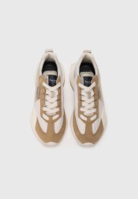 Beige and white sneakers made of suede and mesh, featuring lace-up design, rounded toe, and a textured sole. Notable logo on the side.