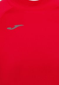 Rotes Sportshirt aus glattem Material mit Rundhalsausschnitt und kurzen Ärmeln. Enthält ein kleines silbernes Logo im Brustbereich.