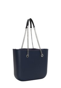 Námořnickomodrá plastová taška s kulatým tvarem, která má černé kožené uši a stříbrné řetízkové akcenty. Logo je vyražené na přední straně.