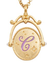 Gold pendant necklace featuring a circular charm with a purple 'C', decorated with star details and two pearl accents.
