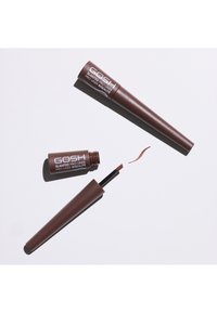 Eyeliner liquide marron avec un applicateur incliné, emballé dans un cylindre marron. Le couvercle a une finition brillante et l'étiquette est en texte argenté.