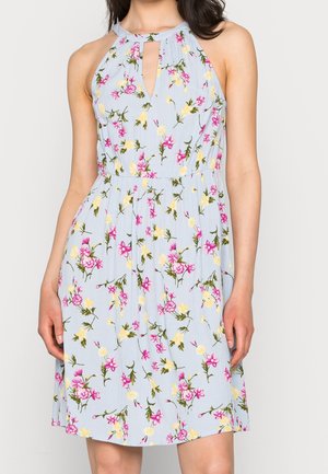 Mouwloze lichtblauwe jurk met roze en gele bloemenprint, halterhalslijn en een open detail op de borst.