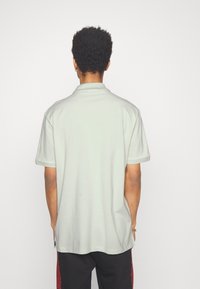 HUGO DONOS - Polo - light pastel green