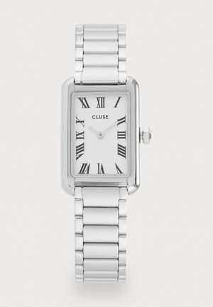 Orologio rettangolare argento con cinturino in metallo lucido. Il quadrante bianco presenta numeri romani neri e un semplice movimento a due lancette.