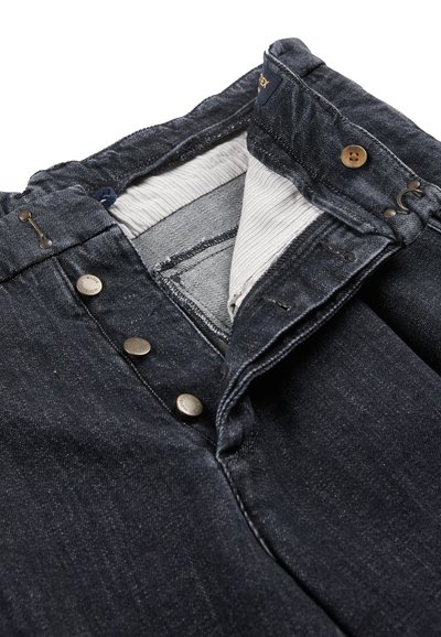 Jeans in denim scuro con chiusura a bottoni, dotati di accessori in argento e fodera interna a righe leggere. Il tessuto presenta una leggera texture.