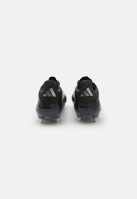 Black soccer cleats with textured upper, silver branding accents, and six molded studs on each sole for grip on grass surfaces.