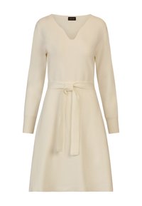 Strickkleid in Creme mit V-Ausschnitt, langen Ärmeln und tailliertem Bund. A-Linien-Form, weicher Griff und einfarbig ohne Muster.
