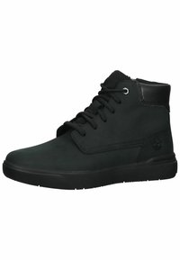 Black mid-top shoes made of smooth leather. Features include black laces, a padded collar, and a textured rubber sole with a logo accent.