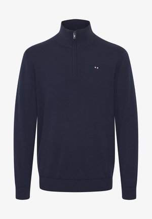 Mornarska pulover z dolgimi rokavi in polovičnim zadrgo, izdelan iz gladkega materiala. Ima majhen, večbarven logo na levem prsnem delu.