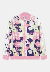 Blommig bomberjacka med zip-stängning, rosa, lila och grön mönster, tre vita ränder på ärmarna, ribbade manschetter och krage.