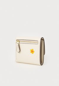 Cream-colored leather wallet with a zipper, featuring a yellow flower sticker and black piping along the edges. Compact and rectangular shape.