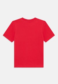 T-shirt rossa in cotone con maniche corte, scollatura rotonda e una superficie liscia. Nessun motivo o grafica. Finitura pulita sulle maniche e sull'orlo.