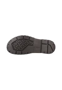 Suela de zapato de goma negra con profundas estrías. Presenta un patrón texturizado para tracción, bordes reforzados y un perfil general plano.