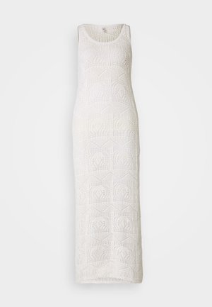 White crochet maxi dress featuring a scoop neckline, sleeveless design, and geometric patterns throughout the fabric texture.