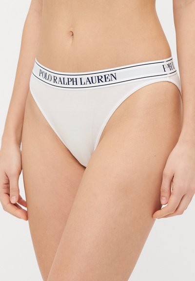 White cotton thong with a wide elastic waistband featuring the logo "POLO RALPH LAUREN" in navy. Smooth texture, minimal design.