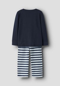 Tumesinine pikkade varrukatega särk koos triibuliste tumesiniste ja valgete ööpüksidega. Sile puuvillane kangas, mis on mugava lõikega. Lihtne ümmargune kaelus.