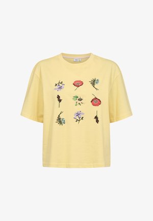 Geel cropped T-shirt met korte mouwen en negen geborduurde kleurrijke bloemen, gerangschikt in een 3x3 raster aan de voorkant.