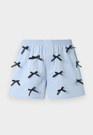 Light blue shorts with an elastic waistband, decorated evenly with multiple small black ribbon bows.