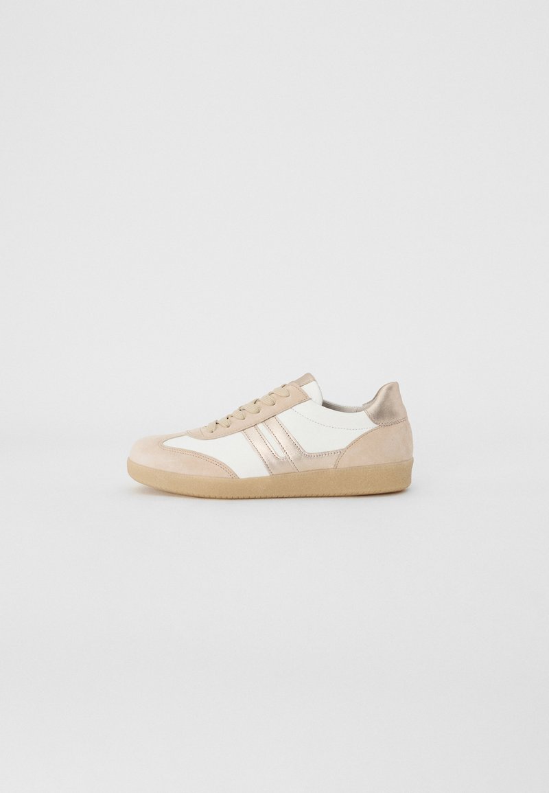 Beige and white sneakers with suede and leather materials. Features a rounded toe, lace-up design, and textured rubber sole.