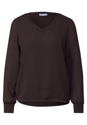 Blouse marron foncé à manches longues, col en V, poignets froncés et ourlet légèrement arrondi, présentée sur un fond blanc uni.
