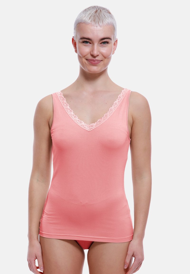 Peach tank top with a V-neckline and delicate lace trim at the edges. Made from smooth, stretchy fabric, fitted design.
