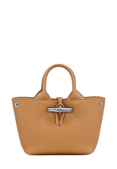 Tan textured leather handbag with rounded handles and a silver twist-lock closure on the front.