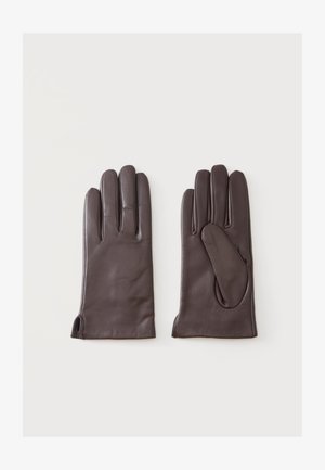 Paire de gants en cuir marron foncé posés à plat sur un fond clair, montrant l'avant et l'arrière avec des détails cousus et de petites fentes au poignet.