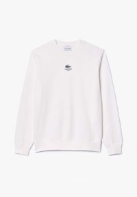 Bílá mikina s dlouhými rukávy, kulatým výstřihem a malým námořnickým logem Lacoste na hrudi. Vyrobena z měkké, hladké látky.