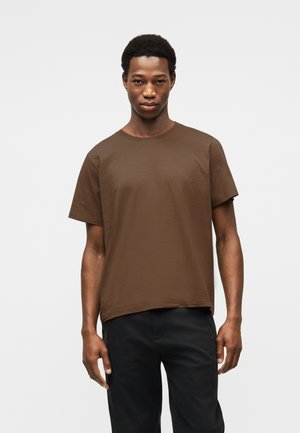 Brown cotton t-shirt with short sleeves, round neckline, and a relaxed fit. Plain design, smooth texture, minimal detailing.